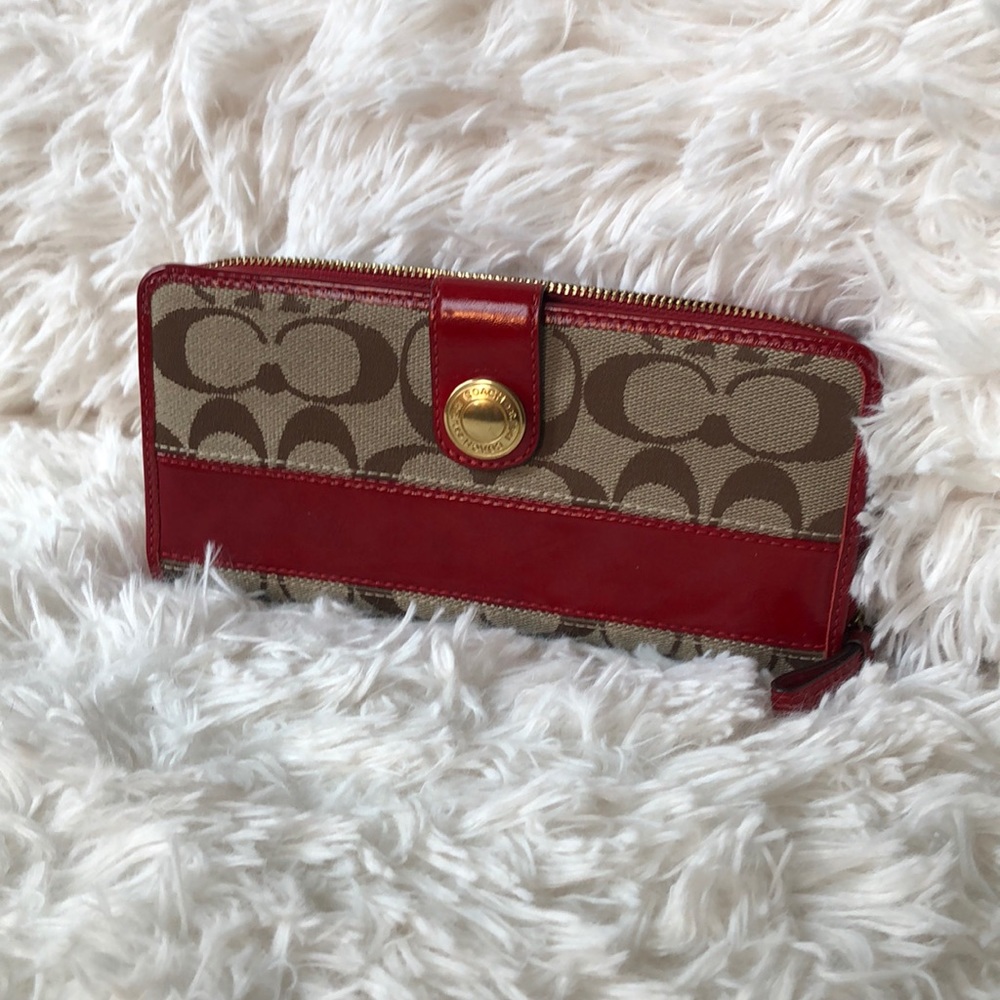 Coach signature zip wallet.